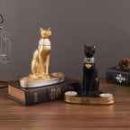 Statue and candlestick of the Egyptian cat goddess Bastet.